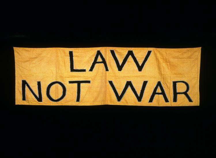 Family Mediation in Stevenage words in gold plated panel with black background reads law not war